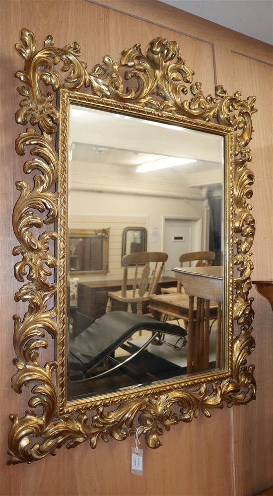 A modern gilt framed Florentine wall mirror, with a foliate border H.110cm
